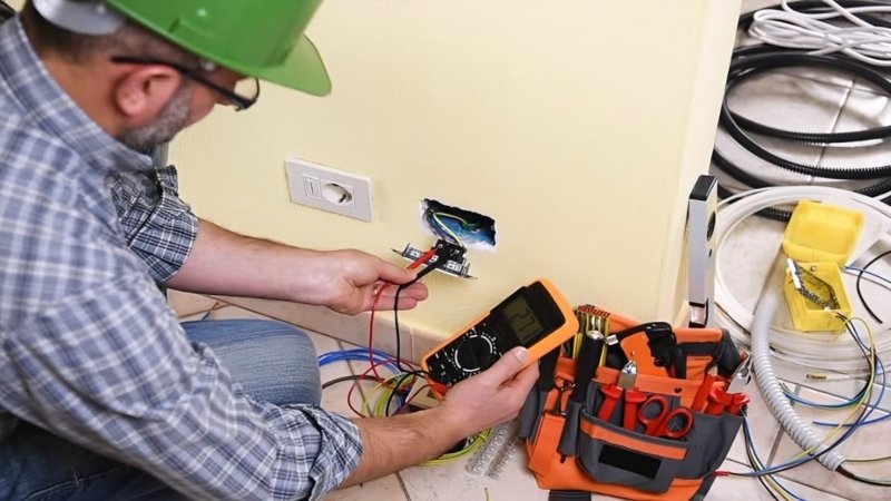 Electrician in Strathfield inspecting old wiring in a period home switchboard
