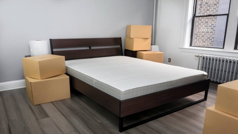 Mattress in a box unrolling and expanding on bed frame